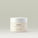 Whipped Body Velvet an intensely rich buttermelt. The product contains Madagascan vanilla extract, baobab oil, and rarabe butter. The packaging is a frosted, white jar with a white lid and a minimalistic design.